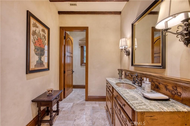 22931 Sonriente Trl, Coto De Caza, CA 92679 - bathroom featuring baseboards, vanity, and stone finish flooring