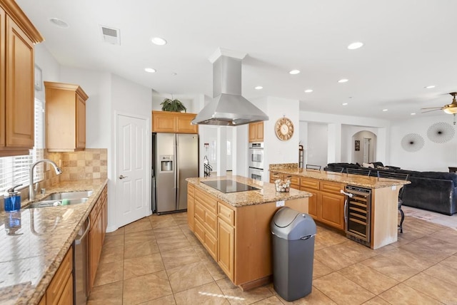 kitchen featuring a center island, wine cooler, stainless steel appliances, a sink, and island range hood