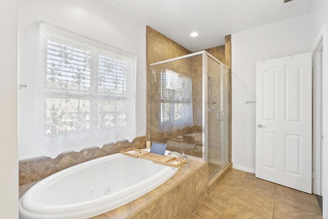 bathroom featuring a stall shower and a bath