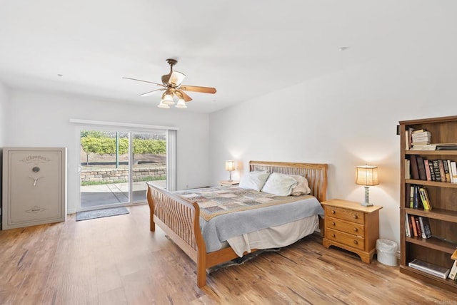 bedroom featuring light wood-style floors, access to outside, and a ceiling fan