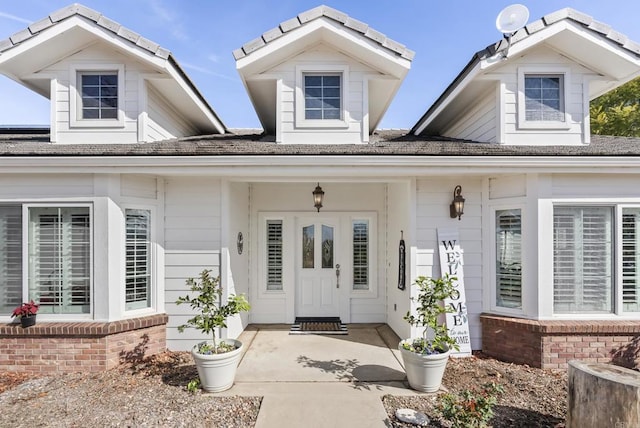 doorway to property with brick siding