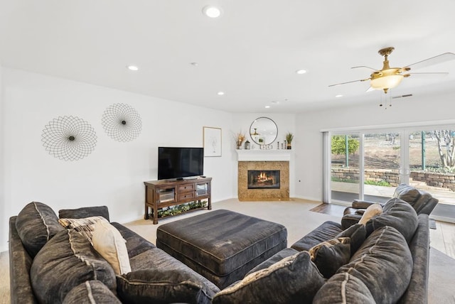 living area with a fireplace with flush hearth, baseboards, ceiling fan, and recessed lighting