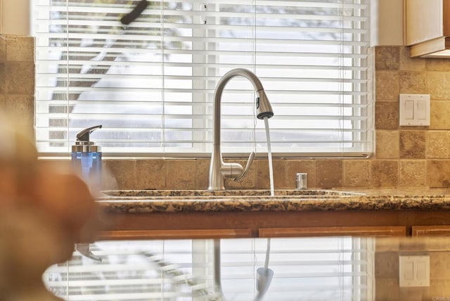 details with a sink and decorative backsplash