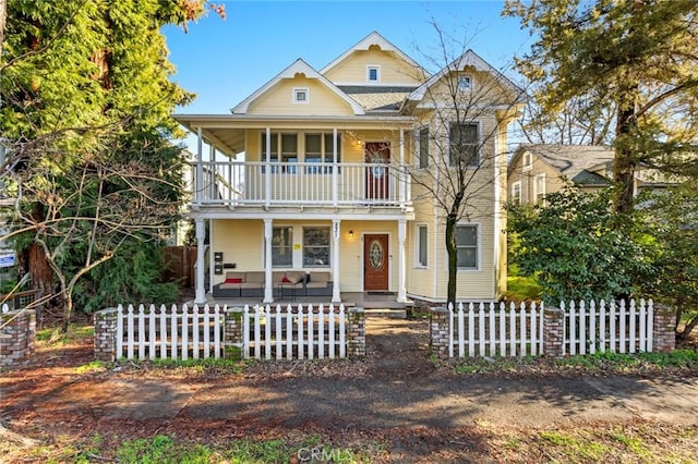 view of front of property featuring a balcony and a porch