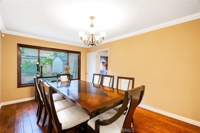 dining space with an inviting chandelier, dark hardwood / wood-style flooring, and crown molding