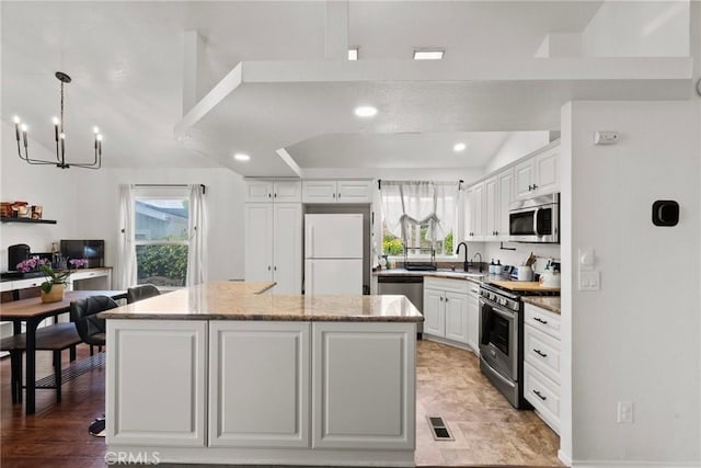 20095 Shadow Island Dr, Canyon Country, CA 91351 - kitchen with stainless steel appliances, a center island, and white cabinets