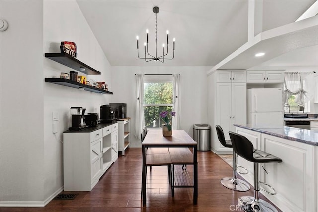 20095 Shadow Island Dr, Canyon Country, CA 91351 - dining space featuring lofted ceiling, dark hardwood / wood-style flooring, and a chandelier
