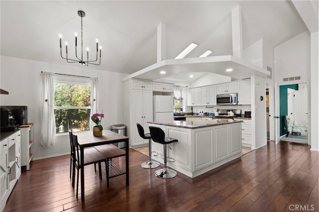 20095 Shadow Island Dr, Canyon Country, CA 91351 - kitchen featuring pendant lighting, white cabinetry, stove, a center island, and white refrigerator
