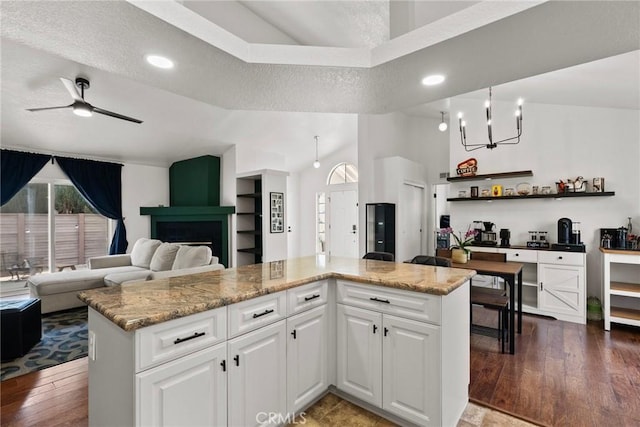 20095 Shadow Island Dr, Canyon Country, CA 91351 - kitchen featuring hardwood / wood-style flooring, white cabinetry, light stone countertops, a textured ceiling, and ceiling fan with notable chandelier
