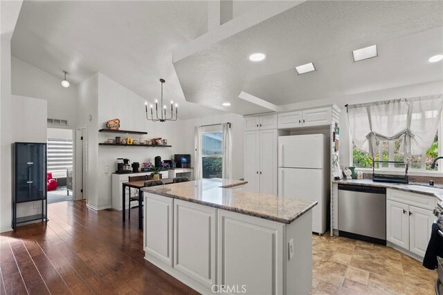 20095 Shadow Island Dr, Canyon Country, CA 91351 - kitchen with pendant lighting, dishwasher, white cabinetry, a center island, and white refrigerator