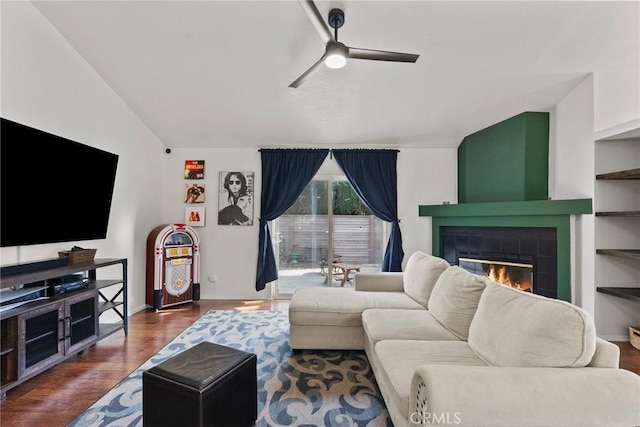20095 Shadow Island Dr, Canyon Country, CA 91351 - living room with ceiling fan, dark hardwood / wood-style floors, a tiled fireplace, and vaulted ceiling