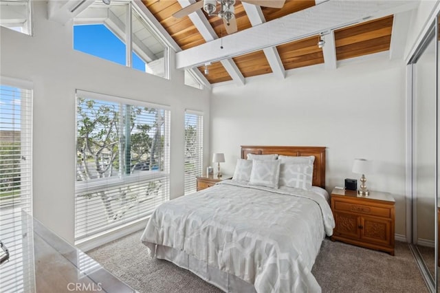 carpeted bedroom featuring beamed ceiling, high vaulted ceiling, and wood ceiling