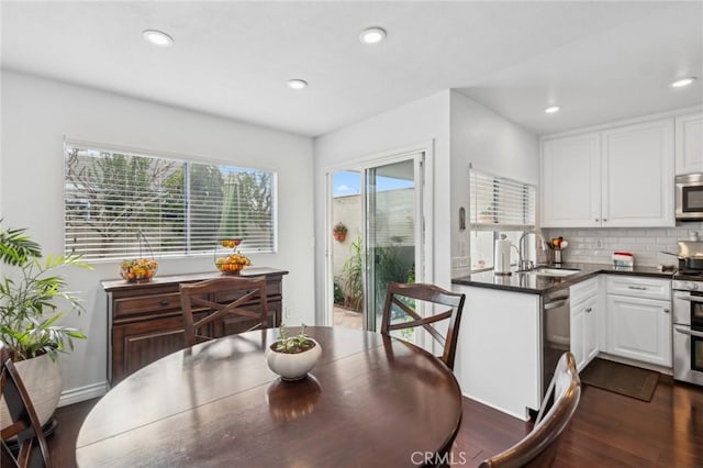 dining space with dark hardwood / wood-style flooring and sink