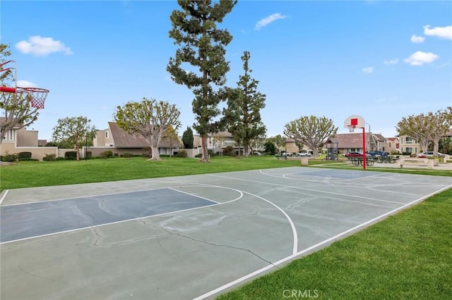 view of basketball court with a yard