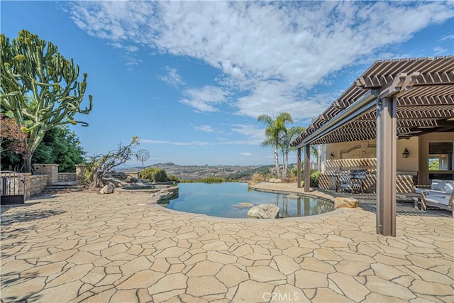 view of swimming pool with a patio, a water view, and a pergola