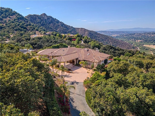 birds eye view of property with a mountain view