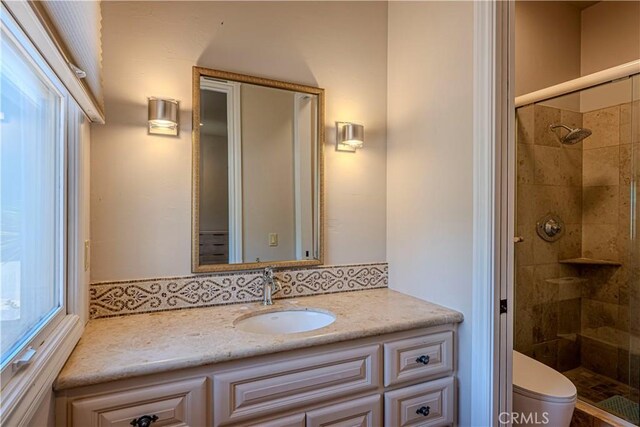 bathroom with vanity, toilet, and walk in shower