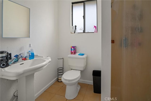 bathroom with sink, tile patterned floors, and toilet