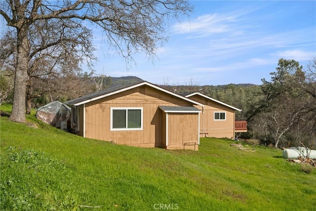 view of outbuilding featuring a yard