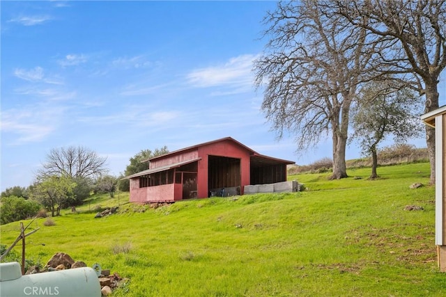 view of outdoor structure featuring a lawn