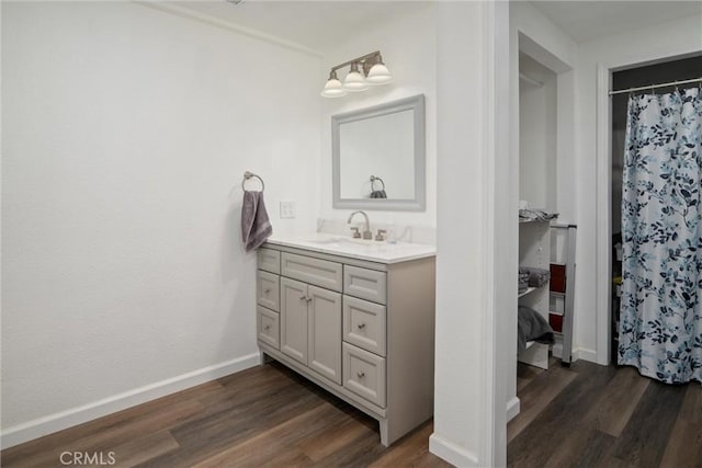 bathroom featuring vanity, wood-type flooring, and walk in shower