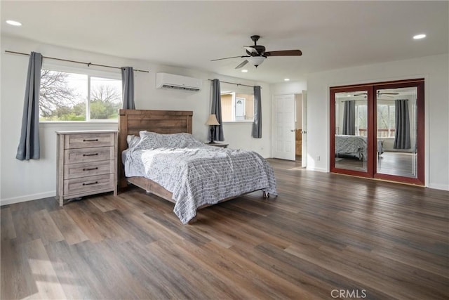 bedroom with dark wood-type flooring, multiple windows, and an AC wall unit