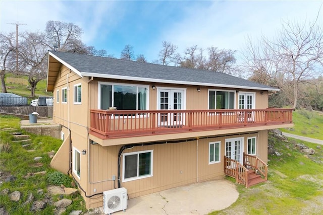 rear view of house with french doors, a patio, and ac unit