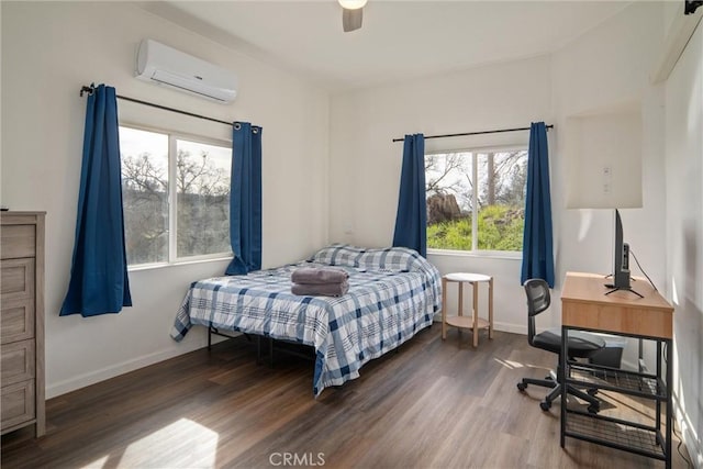 bedroom with dark wood-type flooring, an AC wall unit, and ceiling fan