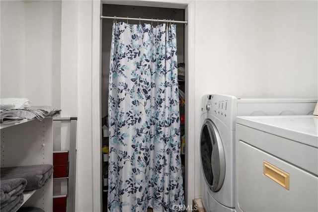 laundry room featuring washer and clothes dryer