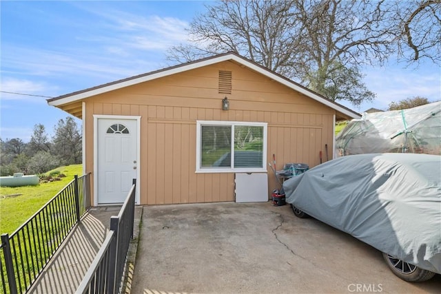 view of outbuilding featuring a lawn