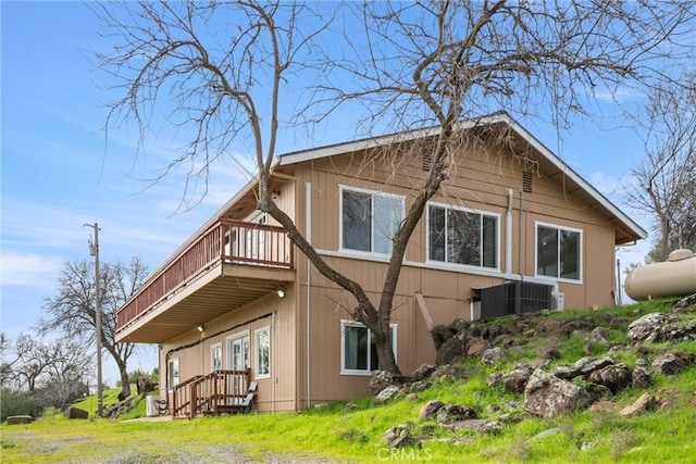 view of side of home with central AC