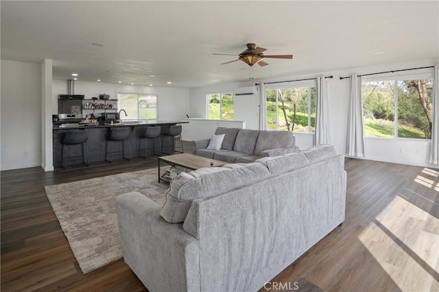 living room featuring sink, dark hardwood / wood-style floors, and ceiling fan