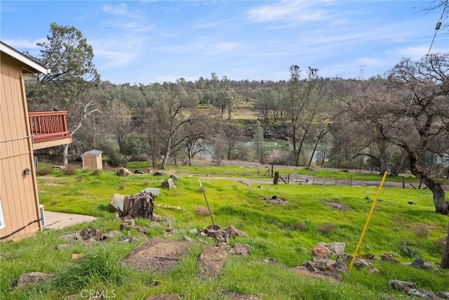 view of yard with a storage unit and a rural view