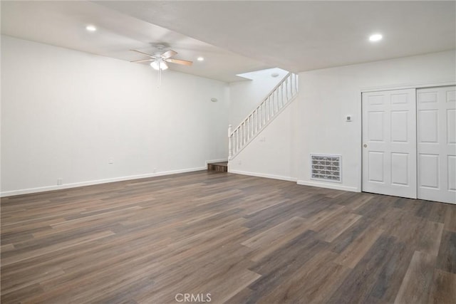 interior space featuring dark wood-type flooring and ceiling fan