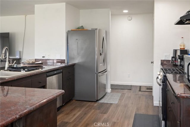 kitchen with stainless steel appliances, dark hardwood / wood-style floors, sink, and dark brown cabinets