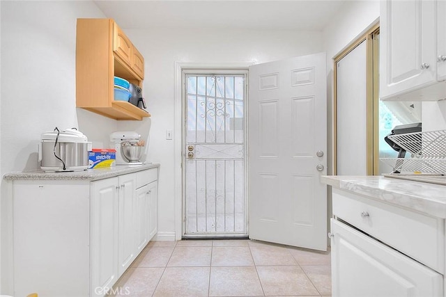 doorway with light tile patterned floors