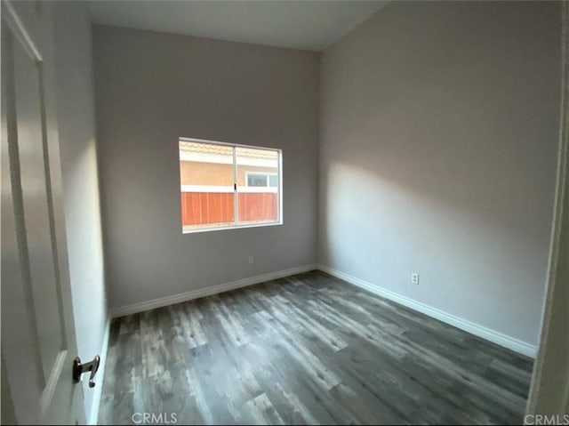 empty room featuring dark wood-type flooring