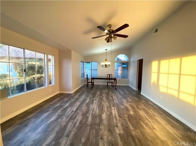 interior space with lofted ceiling, ceiling fan with notable chandelier, and dark wood-type flooring