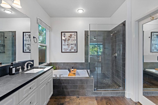 bathroom featuring vanity and shower with separate bathtub