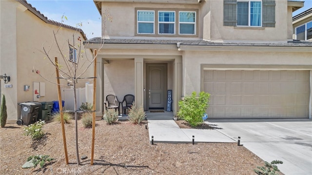 13180 Mesa Ln, Yucaipa, CA 92399 - view of front of home with stucco siding, driveway, and a garage
