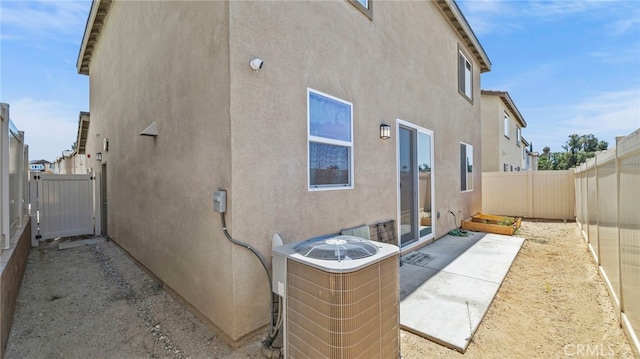 13180 Mesa Ln, Yucaipa, CA 92399 - rear view of property featuring central AC unit, stucco siding, a fenced backyard, and a patio