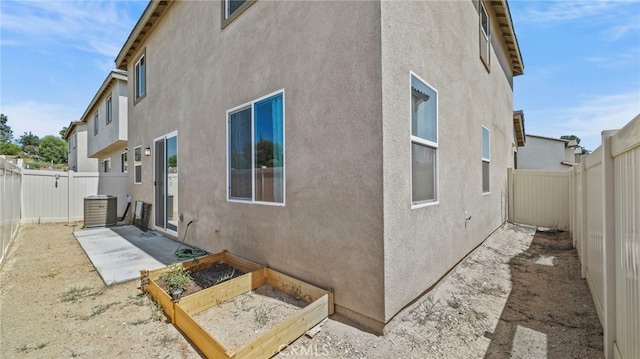 13180 Mesa Ln, Yucaipa, CA 92399 - rear view of property with a vegetable garden, a fenced backyard, and stucco siding