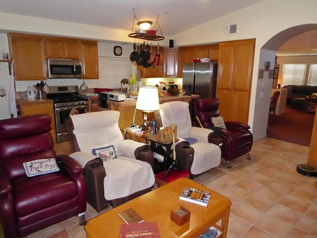 living room featuring lofted ceiling and light tile patterned floors