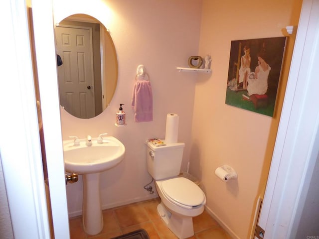 bathroom featuring sink, tile patterned floors, and toilet