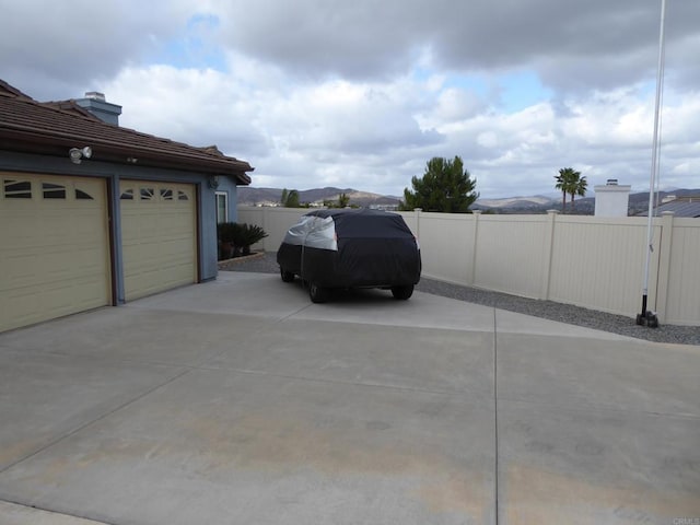 exterior space with a garage and fence