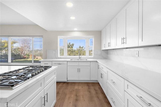 kitchen featuring stainless steel gas cooktop, dishwasher, white cabinetry, and a sink