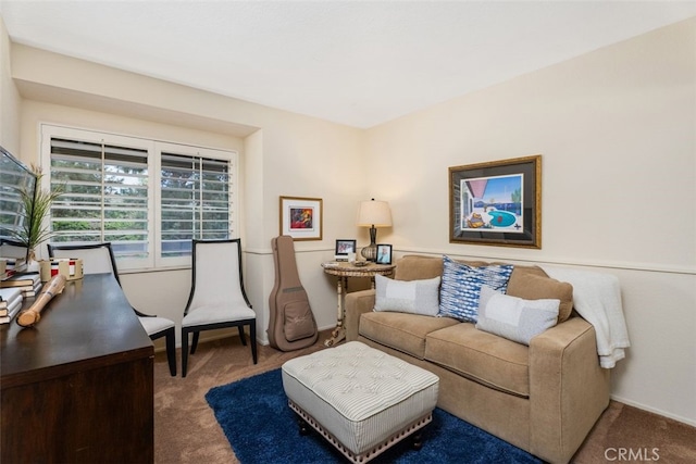 carpeted living area featuring baseboards