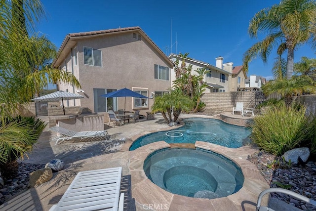 view of swimming pool with a fenced backyard, a fenced in pool, an in ground hot tub, and a patio