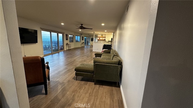 living room featuring hardwood / wood-style floors and ceiling fan