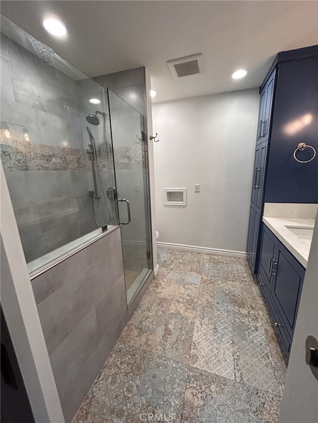 bathroom with walk in shower and vanity